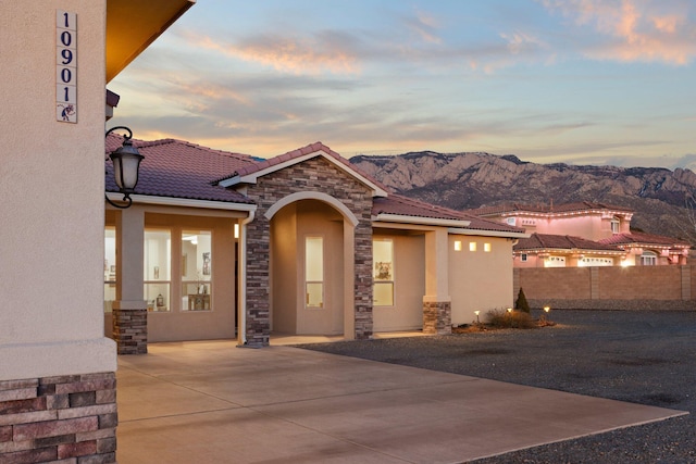 exterior space with a mountain view and a patio