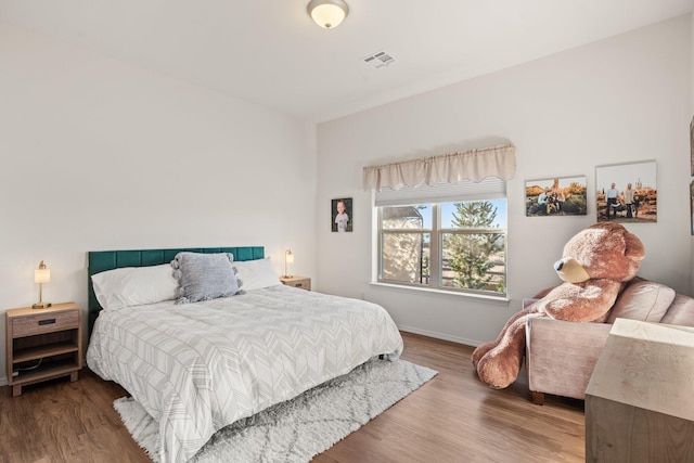 bedroom with hardwood / wood-style flooring