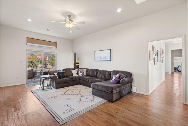 living room featuring light hardwood / wood-style floors and ceiling fan