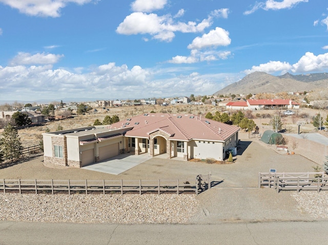 view of front of home with a mountain view and a garage