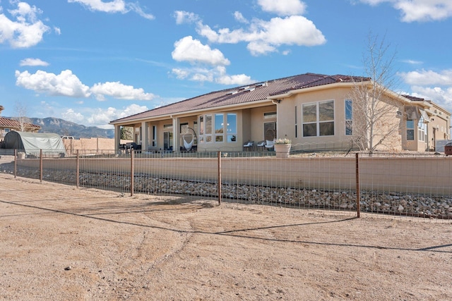 rear view of house featuring a mountain view