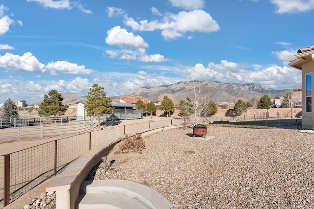 view of yard featuring a mountain view and an outdoor fire pit