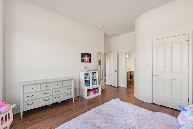 bedroom with dark hardwood / wood-style floors