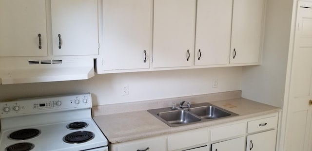 kitchen featuring electric stove, white cabinetry, and sink