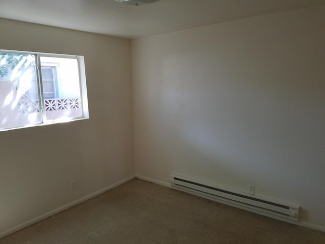 empty room with carpet floors and a baseboard heating unit