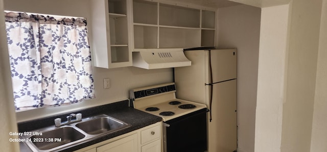 kitchen featuring white fridge, sink, electric range oven, and white cabinets