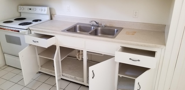 kitchen featuring light tile patterned floors, sink, and electric range