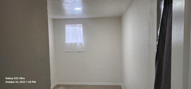 unfurnished room featuring a textured ceiling