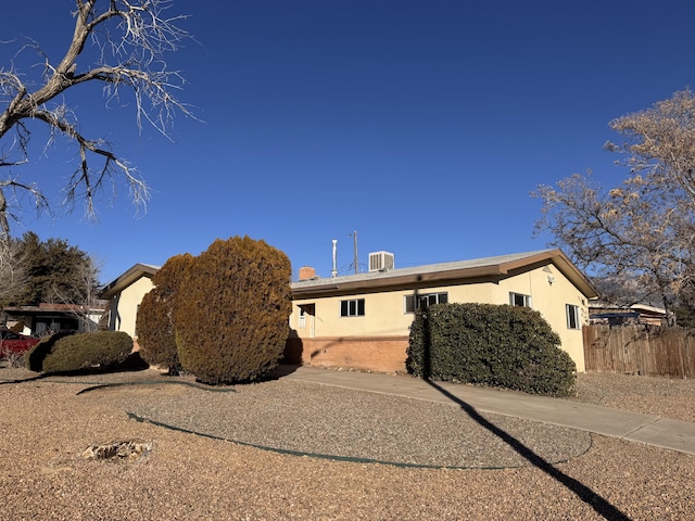 view of side of property with central AC unit