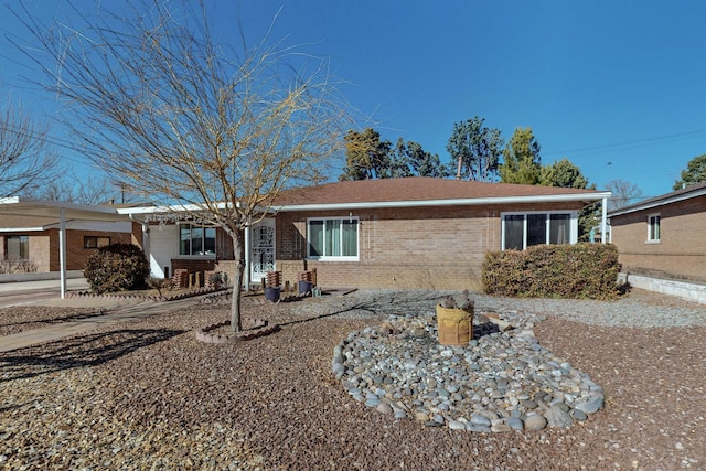 ranch-style house featuring a carport