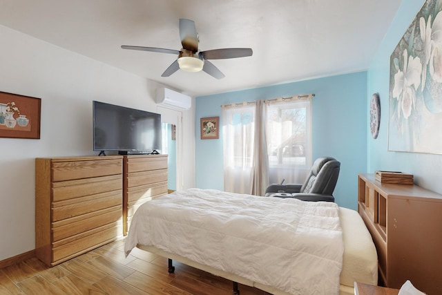 bedroom with ceiling fan, light hardwood / wood-style floors, and a wall unit AC