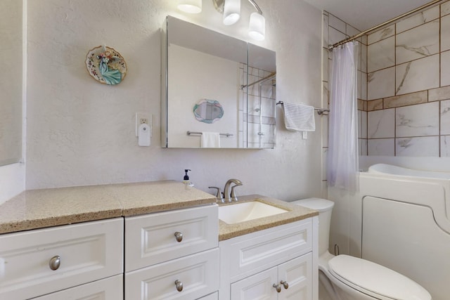 full bathroom with vanity, shower / tub combo, and toilet