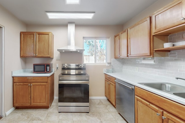 kitchen with tasteful backsplash, wall chimney exhaust hood, stainless steel appliances, and sink