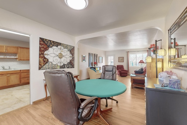 dining area featuring sink and light wood-type flooring