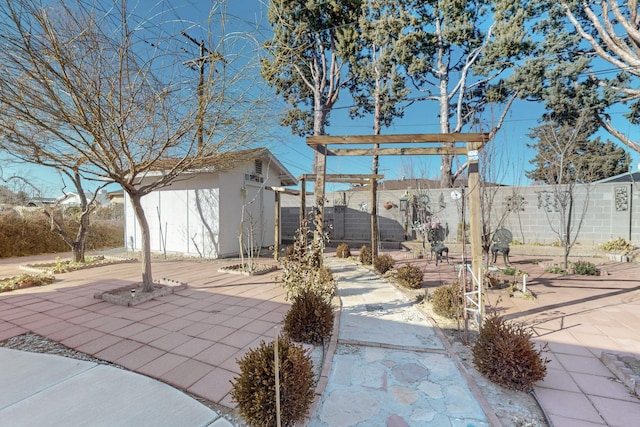 view of patio / terrace featuring a storage unit