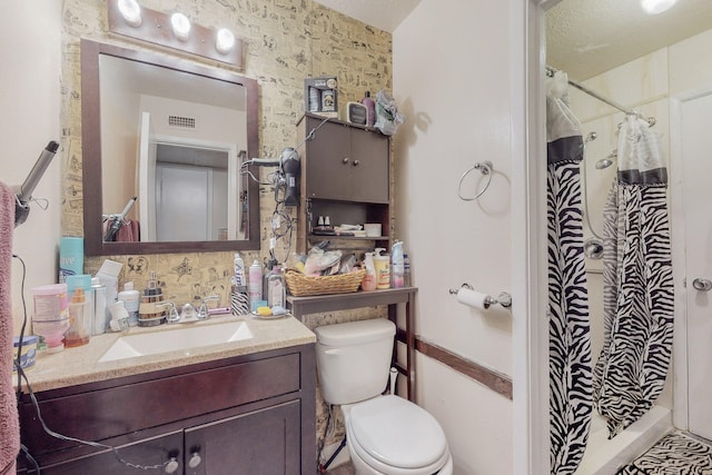 bathroom featuring walk in shower, vanity, and toilet