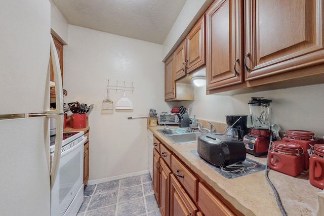 kitchen featuring sink and white appliances