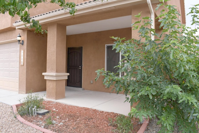 view of exterior entry featuring a garage