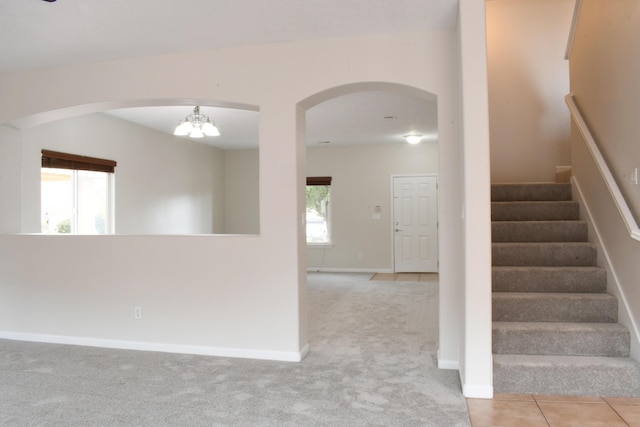 carpeted empty room with plenty of natural light