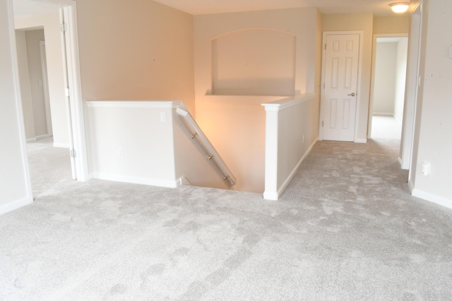 hall featuring light colored carpet