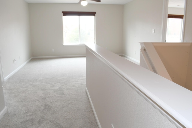 corridor with light colored carpet