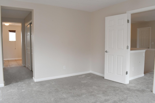 spare room featuring light carpet