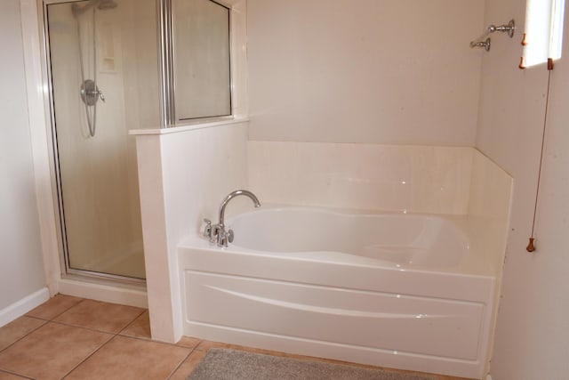 bathroom featuring tile patterned flooring and independent shower and bath