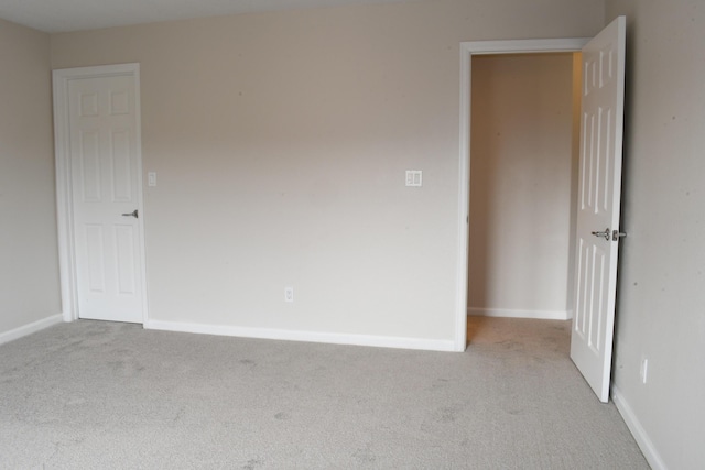 unfurnished room with light carpet