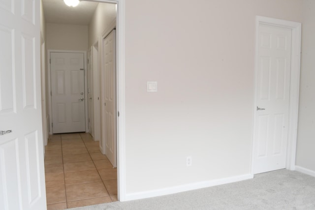 hall with light tile patterned floors