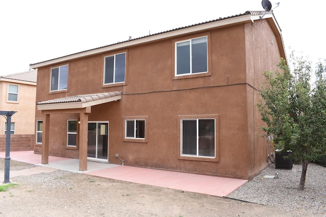 back of property featuring a patio