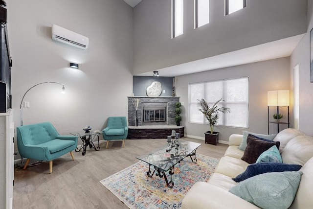 13428 Panorama Loop NE, Albuquerque, NM 87123 - living area with a wall mounted air conditioner, a high ceiling, wood finished floors, a fireplace, and plenty of natural light