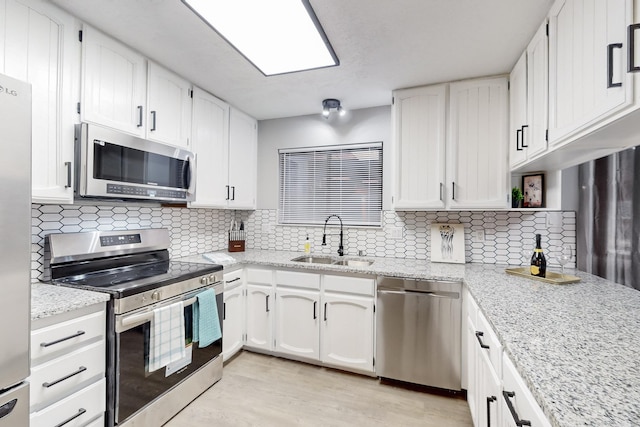 13428 Panorama Loop NE, Albuquerque, NM 87123 - kitchen with stainless steel appliances, a sink, and white cabinets