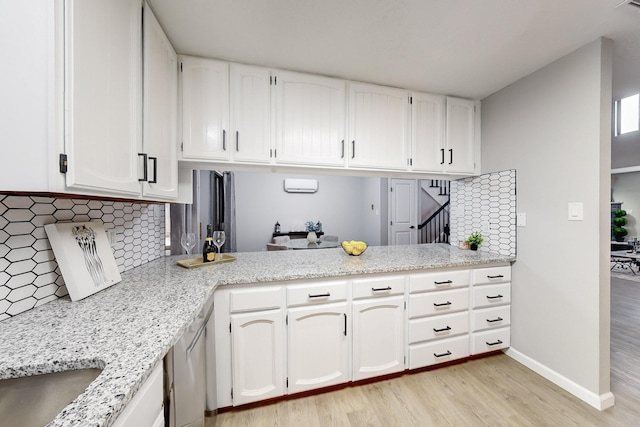 13428 Panorama Loop NE, Albuquerque, NM 87123 - kitchen with light wood finished floors, tasteful backsplash, white cabinets, baseboards, and stainless steel dishwasher