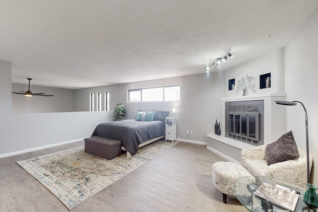 bedroom with wood-type flooring and a textured ceiling