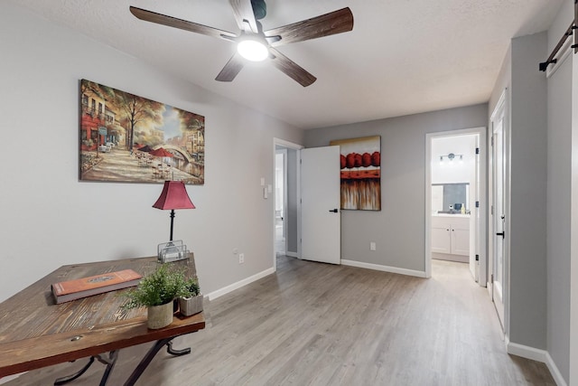 interior space with a barn door and light wood-type flooring