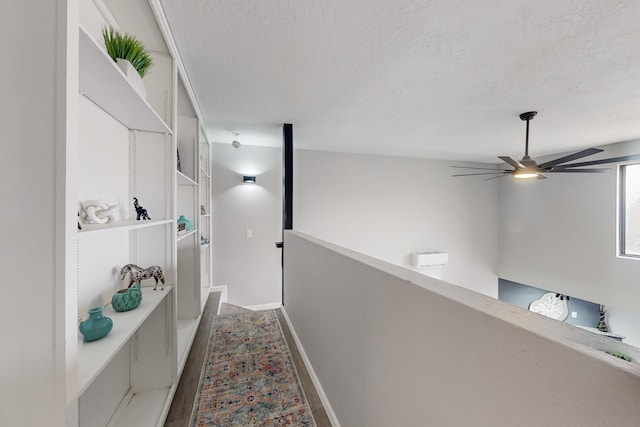 hallway featuring hardwood / wood-style flooring and a textured ceiling