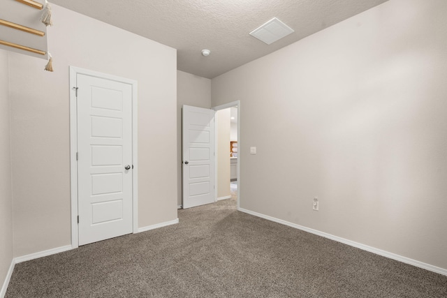 unfurnished bedroom with carpet and a textured ceiling