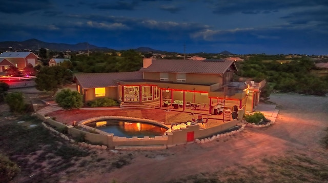 exterior space with a mountain view and a patio