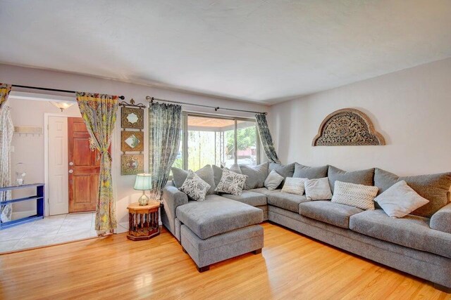 dining space with ceiling fan and light hardwood / wood-style flooring