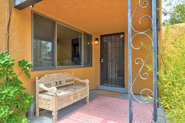 entrance to property with stucco siding