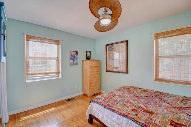 bedroom with ceiling fan and light wood-type flooring