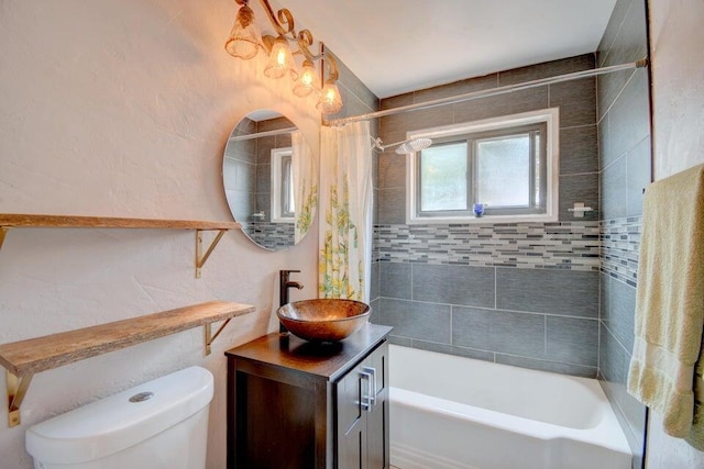 bathroom with toilet, shower / bath combo, vanity, and a textured wall