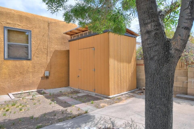 view of shed with fence