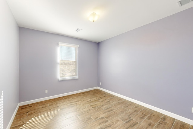 spare room with light hardwood / wood-style flooring