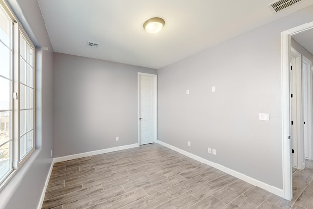 spare room with light hardwood / wood-style floors