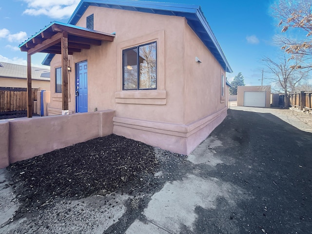 view of home's exterior featuring an outbuilding and a garage