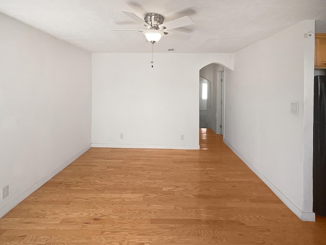 empty room featuring ceiling fan and light hardwood / wood-style floors