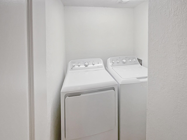 clothes washing area featuring washing machine and dryer