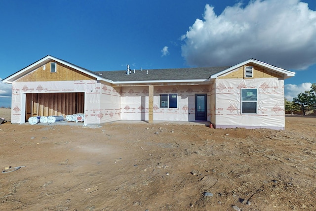 unfinished property featuring an attached garage