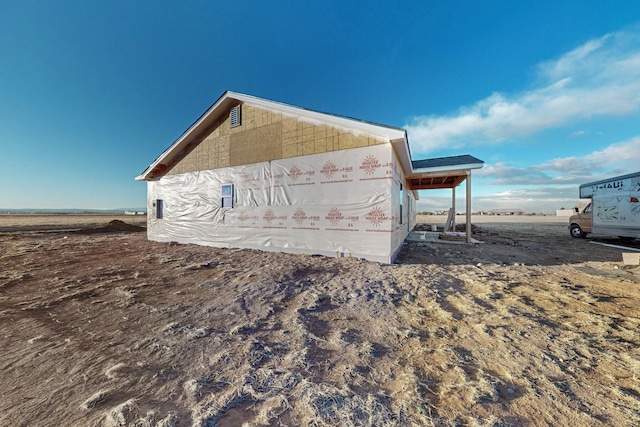 view of property exterior with a rural view